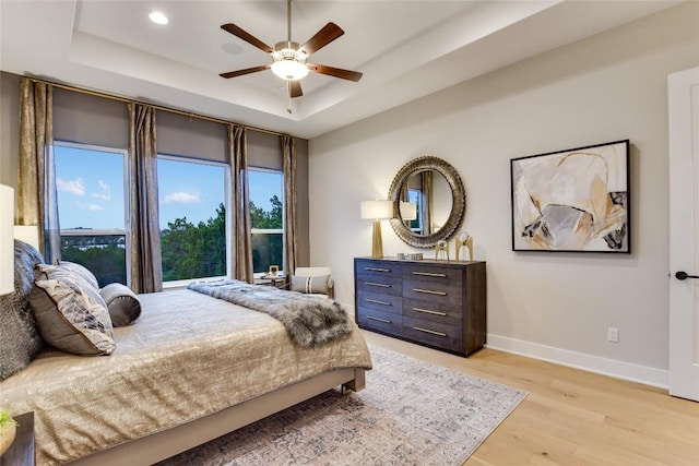 19617 Serenity Ln, Lago Vista, TX 78645 - bedroom with a raised ceiling, light wood finished floors, recessed lighting, and a ceiling fan