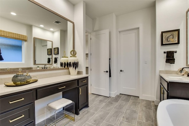 19617 Serenity Ln, Lago Vista, TX 78645 - full bathroom with vanity, a soaking tub, and recessed lighting