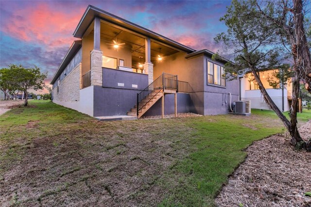 19617 Serenity Ln, Lago Vista, TX 78645 - view of front facade with stairs, a lawn, stone siding, and stucco siding