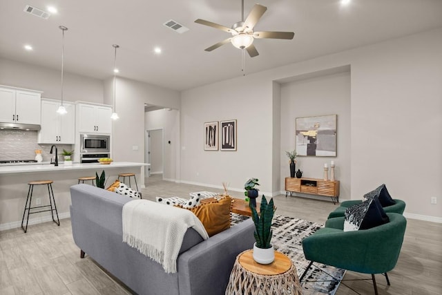 1921 Sauterne Dr, Leander, TX 78641 - living room featuring light wood-type flooring, recessed lighting, and ceiling fan