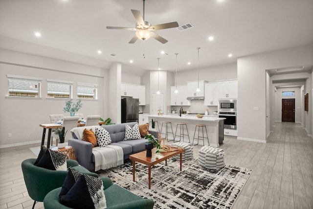1921 Sauterne Dr, Leander, TX 78641 - living area with ceiling fan, light wood finished floors, and recessed lighting