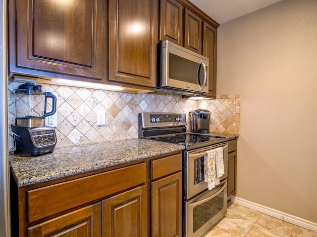 604 Highcrest Dr Unit 722, Granite Shoals, TX 78654 - kitchen with appliances with stainless steel finishes, stone countertops, tasteful backsplash, and light tile patterned floors