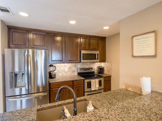 604 Highcrest Dr Unit 722, Granite Shoals, TX 78654 - kitchen with stainless steel appliances, backsplash, light stone counters, and recessed lighting