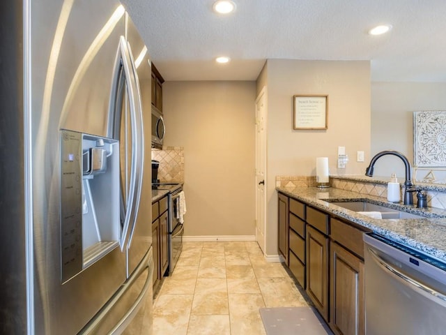604 Highcrest Dr Unit 722, Granite Shoals, TX 78654 - kitchen featuring appliances with stainless steel finishes, tasteful backsplash, stone counters, recessed lighting, and a textured ceiling