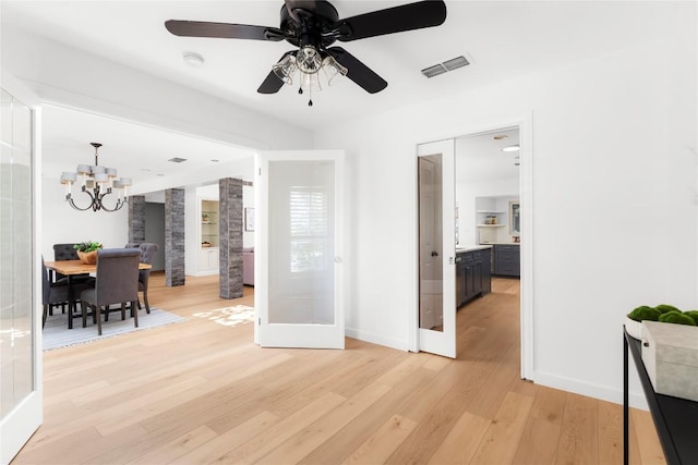 9309 Cedar Forest Dr, Austin, TX 78750 - living room featuring light wood-style flooring, a chandelier, ceiling fan, and french doors