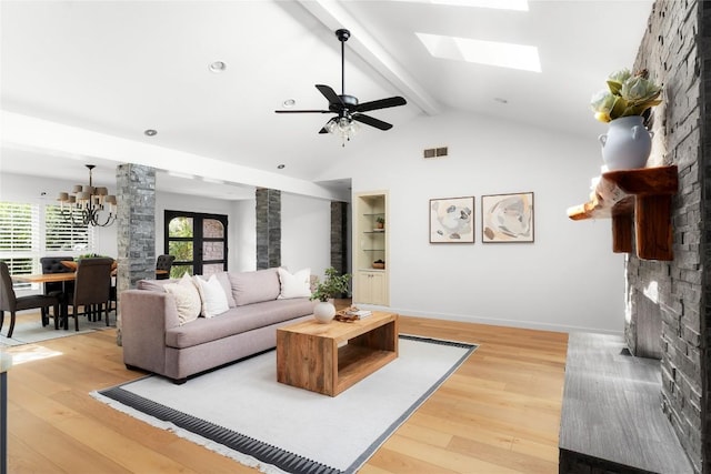 9309 Cedar Forest Dr, Austin, TX 78750 - living area featuring light wood-type flooring, a chandelier, a skylight, and ceiling fan
