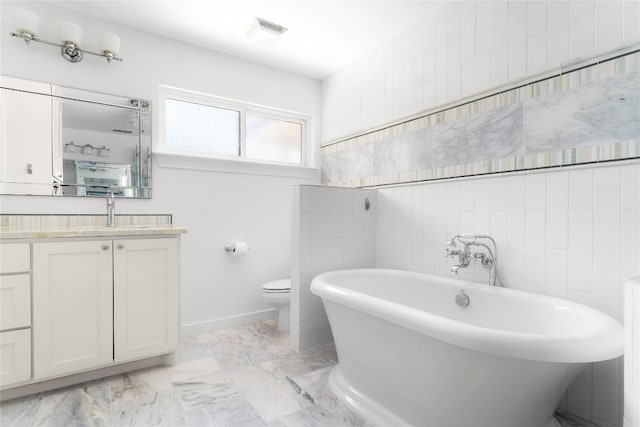 9309 Cedar Forest Dr, Austin, TX 78750 - full bathroom with vanity, a soaking tub, and marble finish flooring