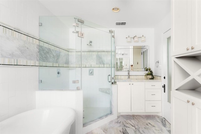 9309 Cedar Forest Dr, Austin, TX 78750 - full bath with a freestanding bath, a shower stall, marble finish flooring, and vanity