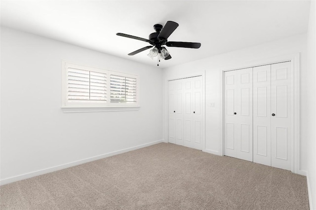 9309 Cedar Forest Dr, Austin, TX 78750 - unfurnished bedroom with multiple closets, carpet flooring, and a ceiling fan