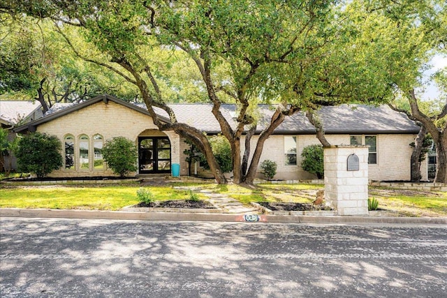 9309 Cedar Forest Dr, Austin, TX 78750 - view of front of house with brick siding and french doors