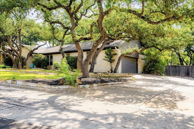 9309 Cedar Forest Dr, Austin, TX 78750 - view of front facade with concrete driveway and an attached garage
