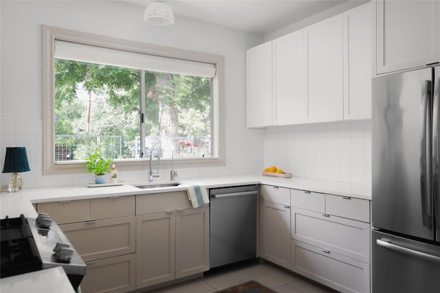 1018 Shelley Ave, Austin, TX 78703 - kitchen featuring appliances with stainless steel finishes, tasteful backsplash, light countertops, and tile patterned flooring