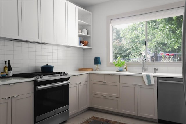 1018 Shelley Ave, Austin, TX 78703 - kitchen featuring appliances with stainless steel finishes, tasteful backsplash, open shelves, and light countertops