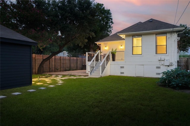 1018 Shelley Ave, Austin, TX 78703 - back of property at dusk featuring crawl space, a fenced backyard, stairs, a shingled roof, and a deck