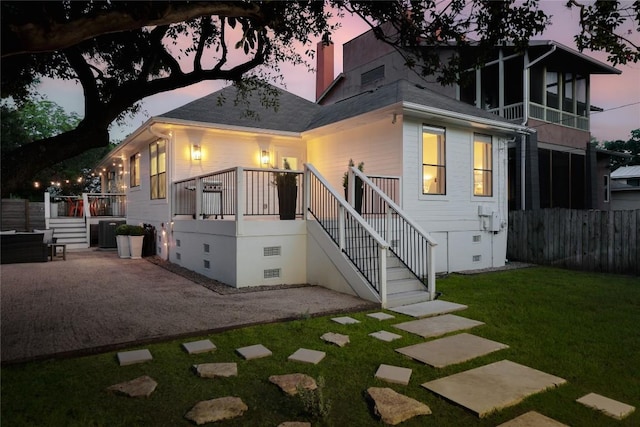 1018 Shelley Ave, Austin, TX 78703 - back of property at dusk with crawl space, a patio area, and stairway