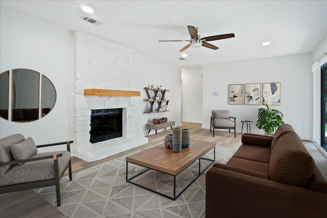 3803 Alexandria Dr, Austin, TX 78749 - living area featuring a ceiling fan, light wood finished floors, a stone fireplace, and recessed lighting
