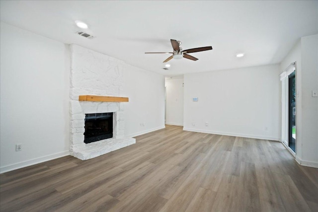 3803 Alexandria Dr, Austin, TX 78749 - unfurnished living room with ceiling fan, wood finished floors, a stone fireplace, and recessed lighting