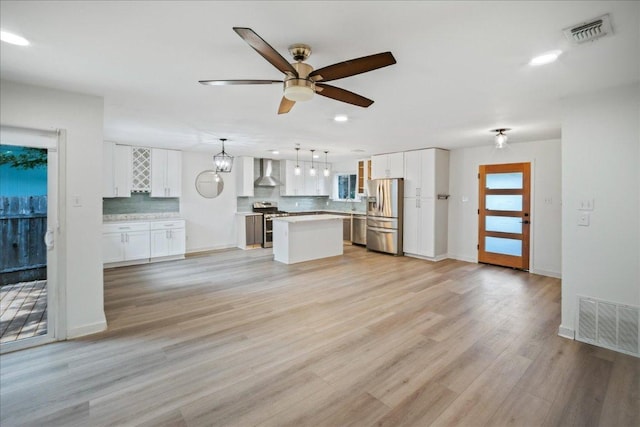 3803 Alexandria Dr, Austin, TX 78749 - unfurnished living room featuring a ceiling fan, recessed lighting, and light wood finished floors