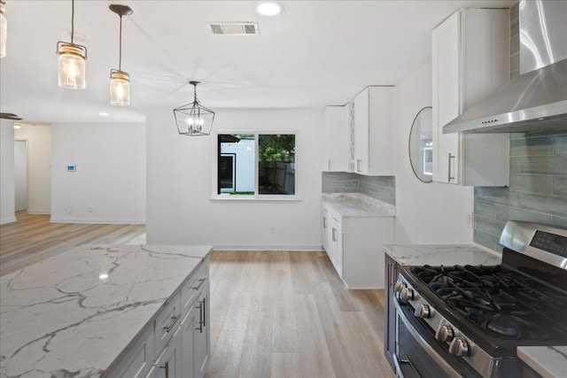 3803 Alexandria Dr, Austin, TX 78749 - kitchen with wall chimney exhaust hood, stainless steel gas range, light stone counters, light wood finished floors, and recessed lighting