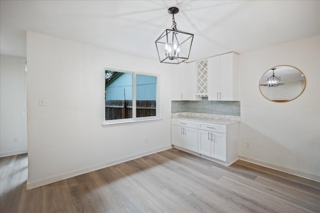 3803 Alexandria Dr, Austin, TX 78749 - unfurnished dining area featuring a chandelier and light wood-style floors
