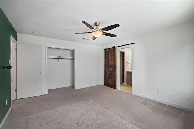 3803 Alexandria Dr, Austin, TX 78749 - unfurnished bedroom with a barn door, light carpet, a closet, ceiling fan, and ensuite bath