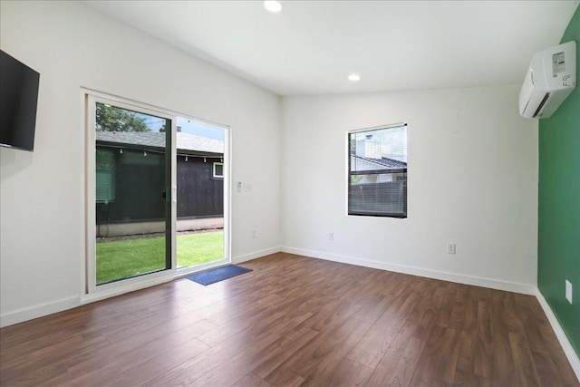 3803 Alexandria Dr, Austin, TX 78749 - empty room with healthy amount of natural light, a wall unit AC, wood finished floors, and recessed lighting