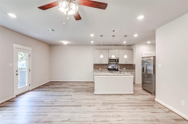 17200C Crane Fly Dr Unit C, Pflugerville, TX 78660 - kitchen with stainless steel appliances, tasteful backsplash, light wood finished floors, recessed lighting, and ceiling fan
