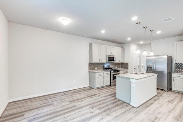 17200C Crane Fly Dr Unit C, Pflugerville, TX 78660 - kitchen with appliances with stainless steel finishes, light wood-style floors, backsplash, light stone countertops, and recessed lighting
