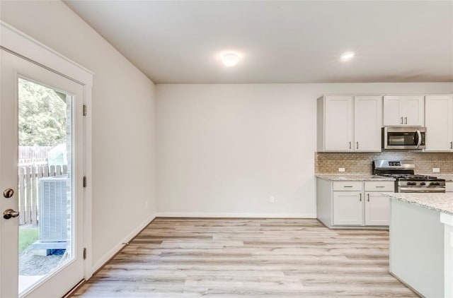 17200C Crane Fly Dr Unit C, Pflugerville, TX 78660 - kitchen with stainless steel appliances, light wood finished floors, tasteful backsplash, light stone counters, and recessed lighting
