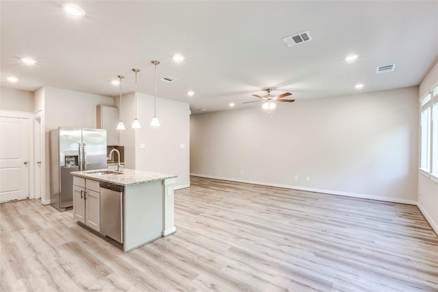 17200C Crane Fly Dr Unit C, Pflugerville, TX 78660 - kitchen featuring appliances with stainless steel finishes, a kitchen island with sink, ceiling fan, light wood-style flooring, and recessed lighting