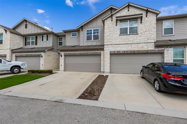 17200C Crane Fly Dr Unit C, Pflugerville, TX 78660 - view of front facade with board and batten siding, stone siding, driveway, and an attached garage