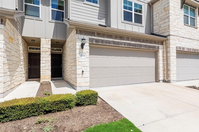 17200C Crane Fly Dr Unit C, Pflugerville, TX 78660 - doorway to property with a garage, stone siding, driveway, and board and batten siding