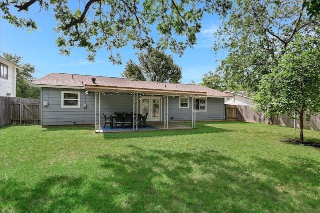 8012 Stillwood Ln, Austin, TX 78757 - back of property featuring french doors, a fenced backyard, and a patio
