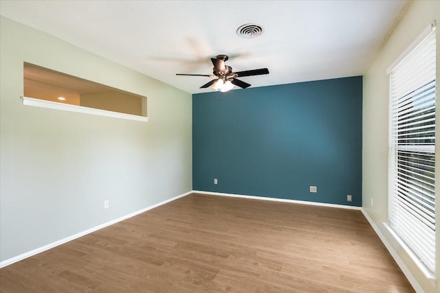 8012 Stillwood Ln, Austin, TX 78757 - empty room with a ceiling fan and wood finished floors