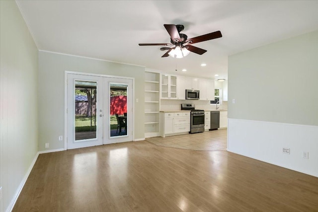 8012 Stillwood Ln, Austin, TX 78757 - unfurnished living room featuring french doors, light wood-style floors, ceiling fan, and crown molding