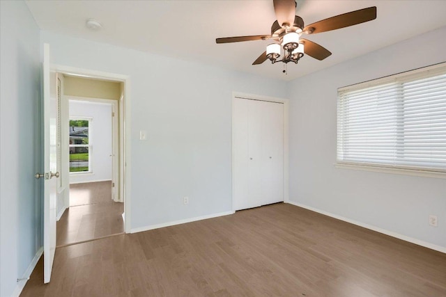 8012 Stillwood Ln, Austin, TX 78757 - unfurnished bedroom featuring wood finished floors, a closet, and a ceiling fan