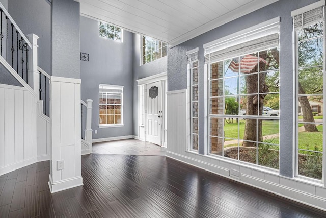 607 County Cork Ln, Leander, TX 78641 - entrance foyer featuring stairs, dark wood finished floors, ornamental molding, and a textured wall