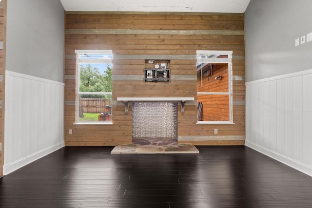 607 County Cork Ln, Leander, TX 78641 - unfurnished living room with hardwood / wood-style flooring, wood walls, and wainscoting