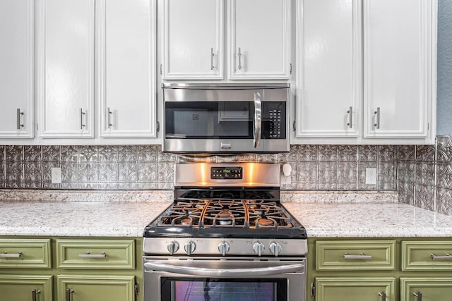 607 County Cork Ln, Leander, TX 78641 - kitchen featuring appliances with stainless steel finishes, white cabinets, and tasteful backsplash