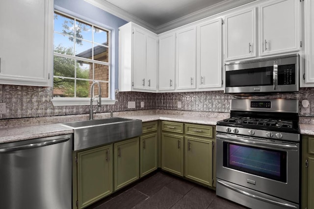 607 County Cork Ln, Leander, TX 78641 - kitchen featuring stainless steel appliances, green cabinets, light countertops, white cabinetry, and decorative backsplash