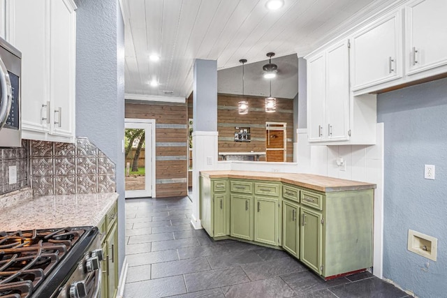 607 County Cork Ln, Leander, TX 78641 - kitchen with green cabinetry, wooden counters, a textured wall, decorative backsplash, and white cabinets