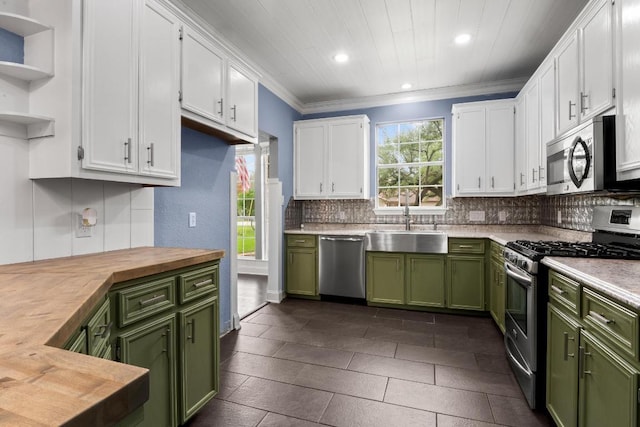 607 County Cork Ln, Leander, TX 78641 - kitchen featuring green cabinets, appliances with stainless steel finishes, white cabinets, recessed lighting, and ornamental molding