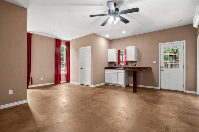 607 County Cork Ln, Leander, TX 78641 - unfurnished living room featuring a ceiling fan, finished concrete flooring, plenty of natural light, recessed lighting, and a wall mounted AC