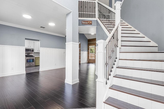 607 County Cork Ln, Leander, TX 78641 - staircase featuring wood finished floors, wainscoting, crown molding, and decorative columns