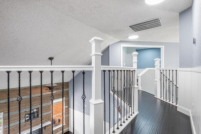 607 County Cork Ln, Leander, TX 78641 - hall with an upstairs landing, a textured ceiling, lofted ceiling, and wood finished floors