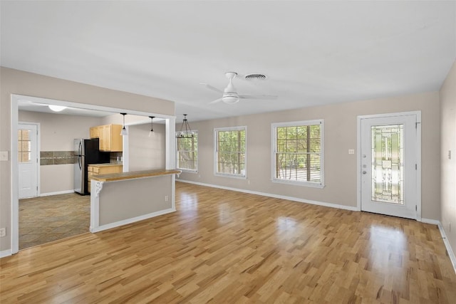 2301 Westworth Cir, Austin, TX 78704 - unfurnished living room with light wood-type flooring and a ceiling fan