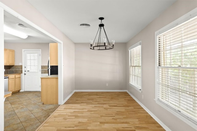 2301 Westworth Cir, Austin, TX 78704 - unfurnished dining area featuring a chandelier and light wood finished floors