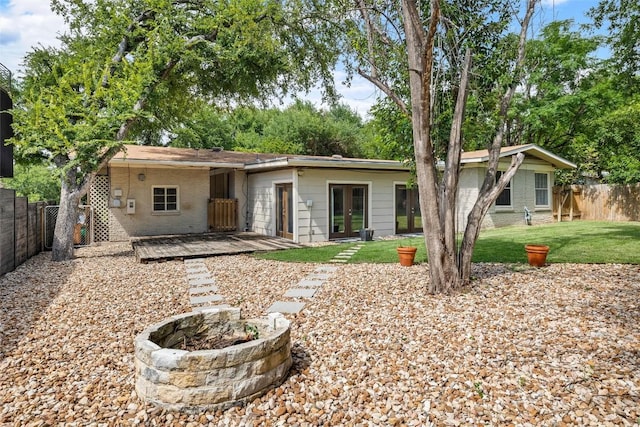 2301 Westworth Cir, Austin, TX 78704 - back of property featuring a fenced backyard, a wooden deck, and french doors
