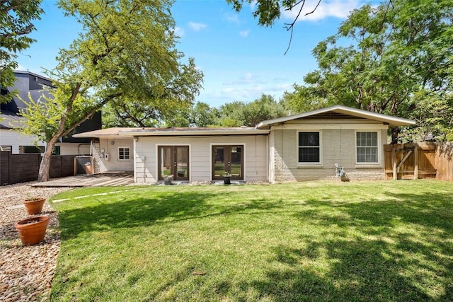 2301 Westworth Cir, Austin, TX 78704 - back of property with french doors and a fenced backyard