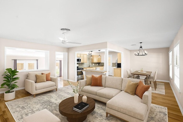 2301 Westworth Cir, Austin, TX 78704 - living room with a chandelier, light wood-style flooring, and a ceiling fan